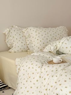 a bed with white sheets and gold stars on it