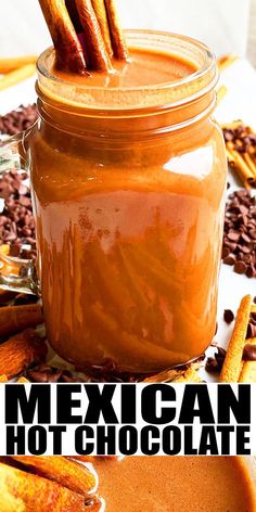 a jar filled with hot chocolate and cinnamon sticks