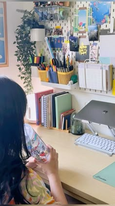 a woman sitting at a desk with a computer