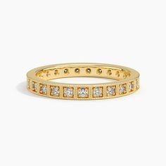 a yellow gold band with rows of diamonds