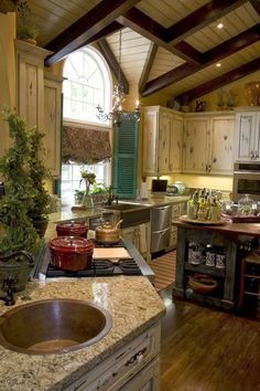 a large kitchen with an island in the middle and lots of counter space on one side