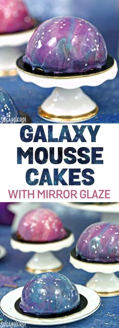 galaxy mouse cakes with mirror glaze are on white plates in front of blue background