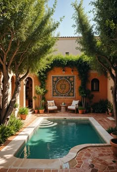 an outdoor swimming pool surrounded by greenery and potted trees with chairs around it