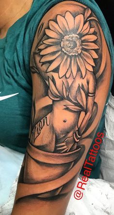 a woman's arm with a sunflower on it and an elephant in the middle