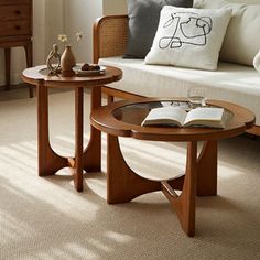 two wooden tables sitting next to each other on top of a carpeted living room floor