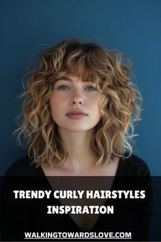 Young woman with curly, shoulder-length hair against a blue background. Side Swept Curly Hair, Curly Hair Face Framing Layers Shoulder Length, Curly Shag Medium Length, Short Natural Curly Hair With Bangs, Midlength Curly Hair, Medium Length Curly Shag, Semi Curly Hairstyles, Shag Curly Hairstyles, Curly Mid Length Hairstyles