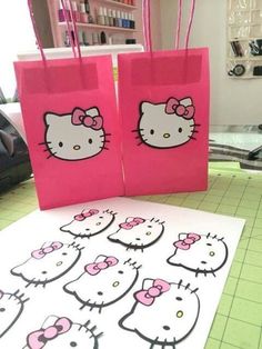 two hello kitty bags sitting on top of a table