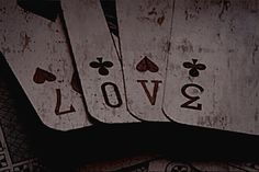 four playing cards with the word love written on them