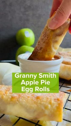 a person dipping an apple pie into a small bowl with the words granny smith's apple pie egg rolls