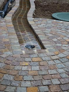 a brick walkway with water coming out of it