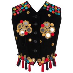 Oh! Jackie is delighted to offer this important and rare Fall 1992 Dolce & Gabbana appliquéd velvet vest. Indulge in the epitome of true vintage glamour with this runway, ad campaign and TV series documented masterpiece that transcends time. This exquisite black pure cotton velvet waistcoat, adorned with mirrors, pom-poms, and tassels at the hem, is made in Italy and a testament to Dolce & Gabbana's unparalleled craftsmanship. Like several other exceptional vintage pieces that are already available in the shop, the vest comes direct from a German socialite and fashion collector so has not been on the market prior to this. Perhaps this waistcoat is the piece with the most documentation I ever had in the shop: 1. The exact twin of it was photographed in advance of the runway show. 2. Runway Velvet Waistcoat, Velvet Vest, Vintage Glamour, Black Mirror, True Vintage, Tassels, Dolce And Gabbana, Velvet, Mirror