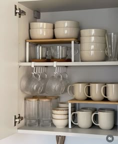 the shelves are filled with dishes and cups