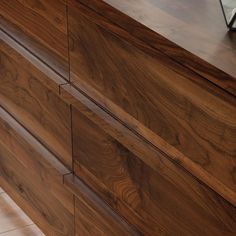 a large wooden dresser sitting on top of a tiled floor