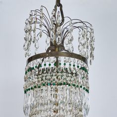 An elegant, bronze and crystal, eight-arm chandelier with 2 emerald green glass plates and green accent crystals. The top tier features a cascade of crystal hovering above long crystal swags, creating a luxurious, but graceful body that terminates in a bronze finial. Wired for USA. Arm Chandelier, Green Accents, Glass Plates, Crystal Chandelier, Finials, Top Tier, Green Glass, Emerald Green, Emerald