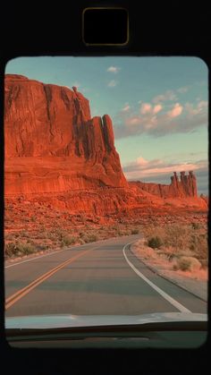 the view from inside a vehicle looking out at mountains and deserts in the distance