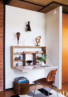 an office with a desk and chair in the corner, next to a brick wall