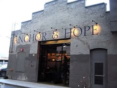 an old brick building with the words anchor and hope on it's front door