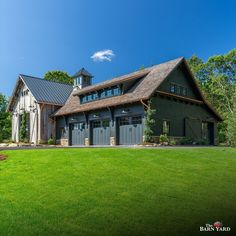 a large barn style house with two garages on the front and side of it