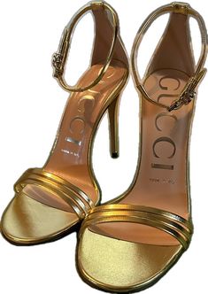 Luxury Gucci Evening Sandals, Designer Gold Heels With 4-inch Heel, Designer Gold Ankle Strap Heels, Gucci Luxury Formal Sandals, Gucci Ankle Strap Sandals For Formal Occasions, Designer Gold Closed Toe Heels, Gucci Designer Formal Sandals, Designer Closed Toe Gold Heels, Gucci Designer Sandals For Formal Occasions