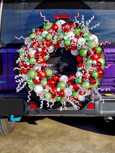 a purple truck with a christmas wreath on the back