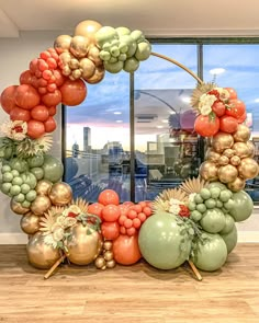 the balloon arch is made up of many different types of balloons, including oranges and green