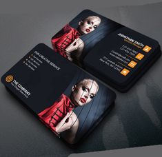 two black business cards with an image of a woman in red on the front and back