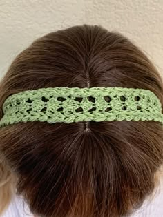 a woman wearing a green crochet headband