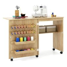 a sewing machine sitting on top of a wooden table next to a shelf filled with craft supplies