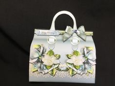 a handbag decorated with flowers and bows