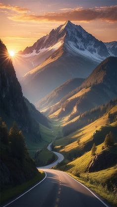 the sun is setting over a mountain range with a winding road in the foreground