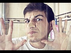 a man holding his hands up in front of his face and making the vulcan sign