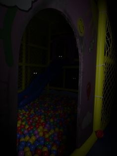 there is a ball pit in the dark with balls all over it and lights on