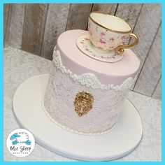 a cake with a cup and saucer on top