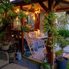 a covered patio with lots of potted plants