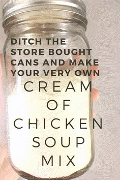 a person holding up a jar filled with cream and chicken soup mix in it's hand