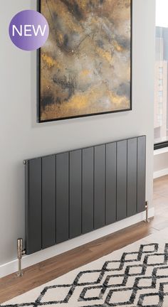 a large painting hanging on the wall above a radiator in a living room