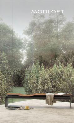 a bench sitting on top of a cement ground next to trees and bushes with the words modloft above it