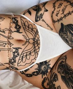 a woman with lots of tattoos on her stomach