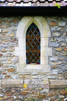 an old stone building with a window in it