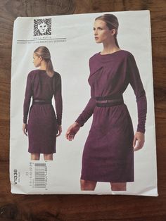 a women's dress sewing pattern with long sleeves and an asymmetric belt