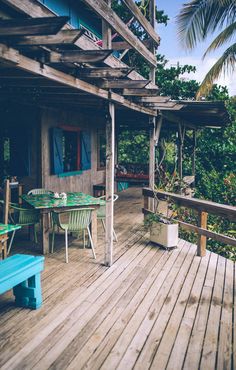 a wooden deck with tables and chairs on it