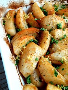 potatoes with herbs and seasoning in a casserole dish