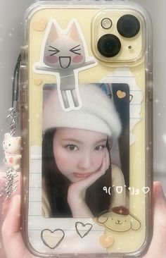 a person holding up a cell phone case with an image of a cat on it