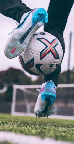 a soccer player is doing a handstand with his foot on the ball in front of him