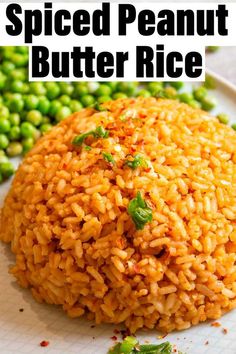 a white plate topped with rice and green peas next to a pile of fried peanut butter rice