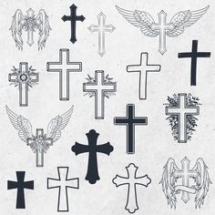 a bunch of cross tattoos on a piece of paper with some wings and crosses in the middle