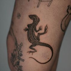 a lizard tattoo on the leg of a man