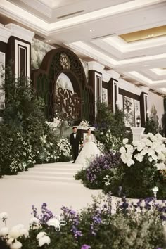 the bride and groom are standing in front of an elaborate floral display at their wedding