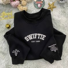 Celebrate your music and nostalgia with the Swiftie Era Sweatshirt, a garment that's not just cozy but also a statement of fandom. Perfect for those chilly evenings or casual outings, this sweatshirt is a tribute to a musical journey that spans decades. Size: Available from S to XXXL, accommodating a full range of body sizes for a comfortable fit. Material: Made with a high-quality cotton blend, it ensures both softness and durability for long-lasting wear. Intended Age Range: While designed with fans in mind, its age-neutral appeal makes it suitable for a wide range of ages, from teens to adults. Special Features: The sweatshirt proudly displays iconic album titles along the sleeves, creating a timeline of musical eras. Technical Specifications: Features a ribbed neck, cuffs, and hem for Winter Hip Hop T-shirt With Letter Print, Winter Hip Hop T-shirt, Hip Hop Winter T-shirt, Hip Hop Crew Neck Winter Tops, Winter Hip Hop Crew Neck Tops, Hip Hop Winter Crew Neck Tops, Hip Hop Fleece Top With Letter Print, Hip Hop Letter Print Fleece Top, Christmas Streetwear Cotton Sweatshirt