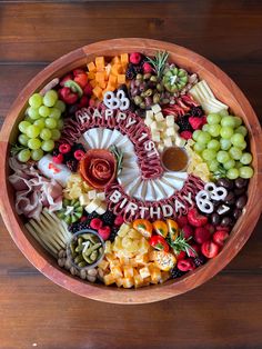 a wooden bowl filled with lots of different types of food